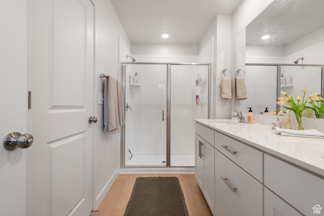 938 W Terracotta Dr, Saratoga Springs, UT 84045 - full bathroom with a stall shower, wood finished floors, double vanity, and recessed lighting