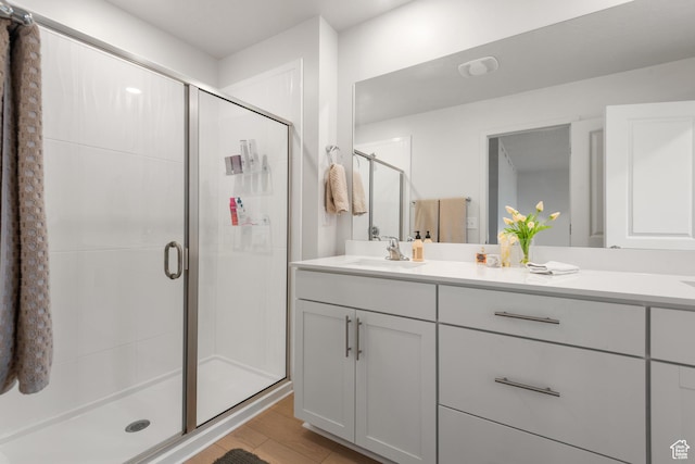 938 W Terracotta Dr, Saratoga Springs, UT 84045 - bathroom featuring a shower stall, vanity, and wood finished floors