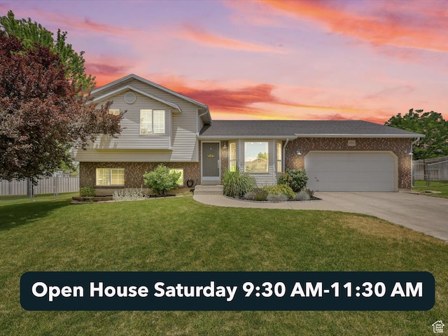 874 W 1145 N, Clinton, UT 84015 - split level home featuring brick siding, an attached garage, and driveway
