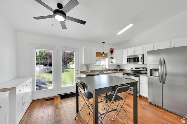 874 W 1145 N, Clinton, UT 84015 - kitchen featuring stainless steel appliances, white cabinets, lofted ceiling, and light wood-type flooring