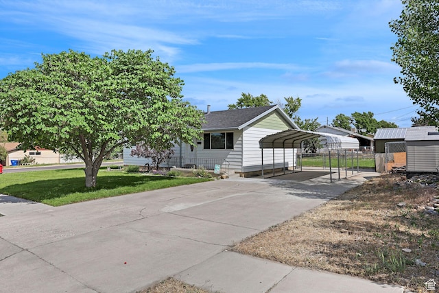784 W 700 S, Brigham City, UT 84302 - view of front of house with a detached carport, driveway, and roof with shingles