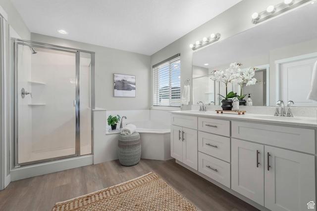 1666 W Rockaway Ln, West Jordan, UT 84084 - full bathroom with double vanity, a stall shower, a bath, and wood finished floors