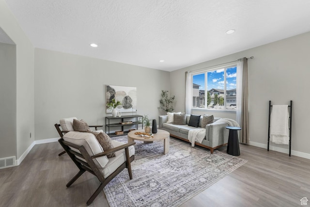 1666 W Rockaway Ln, West Jordan, UT 84084 - living room featuring wood finished floors, recessed lighting, and a textured ceiling