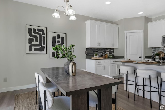 1666 W Rockaway Ln, West Jordan, UT 84084 - dining room featuring dark wood-style flooring, recessed lighting, and a chandelier