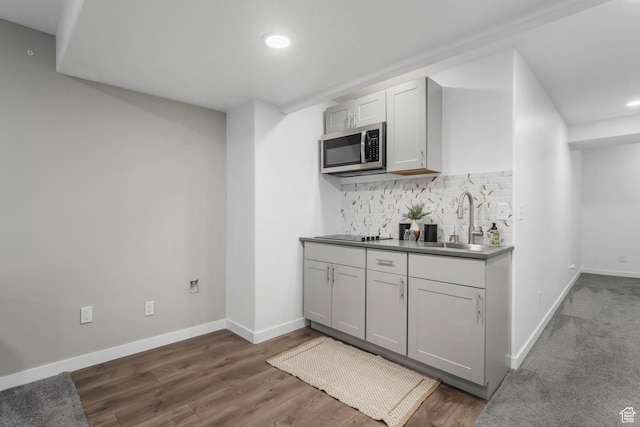 1666 W Rockaway Ln, West Jordan, UT 84084 - kitchen with stainless steel microwave, tasteful backsplash, recessed lighting, dark wood-style flooring, and black electric cooktop