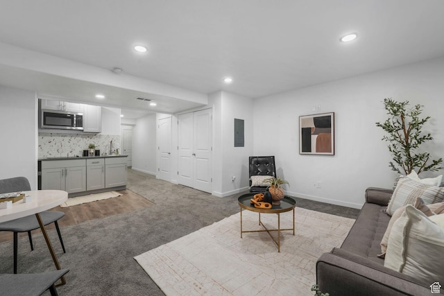 1666 W Rockaway Ln, West Jordan, UT 84084 - carpeted living area featuring wet bar, electric panel, and recessed lighting