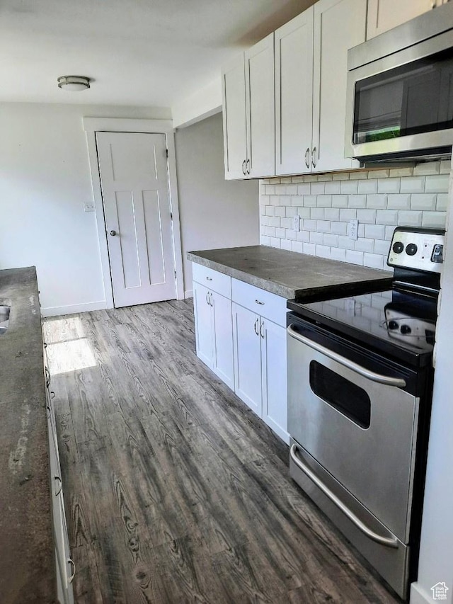 1018 E 40 N, Springville, UT 84663 - kitchen with stainless steel appliances, dark wood-type flooring, white cabinetry, and decorative backsplash