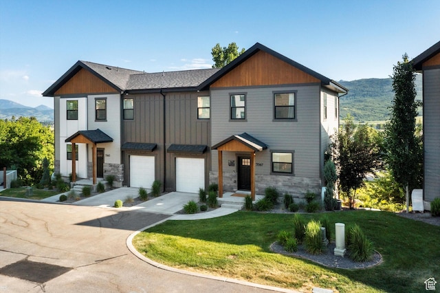 3547 N Creekside Way, Eden, UT 84310 - view of front of house featuring stone siding, driveway, an attached garage, and a mountain view