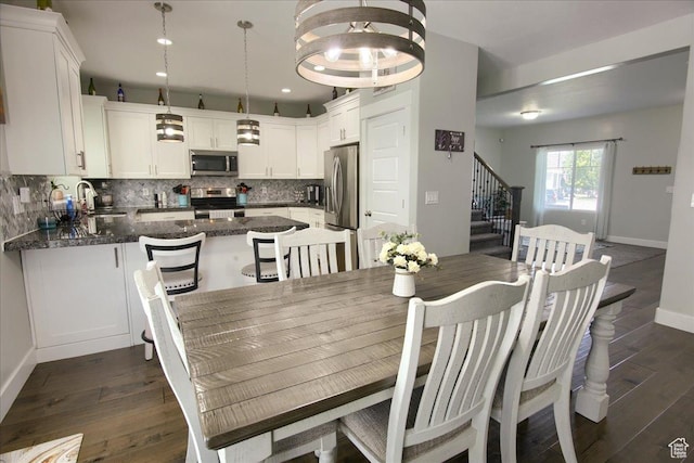 342 E Chiswick Ct, Stansbury Park, UT 84074 - dining space featuring stairway, dark wood finished floors, and recessed lighting