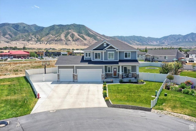 342 E Chiswick Ct, Stansbury Park, UT 84074 - craftsman inspired home featuring covered porch, driveway, a mountain view, and stone siding