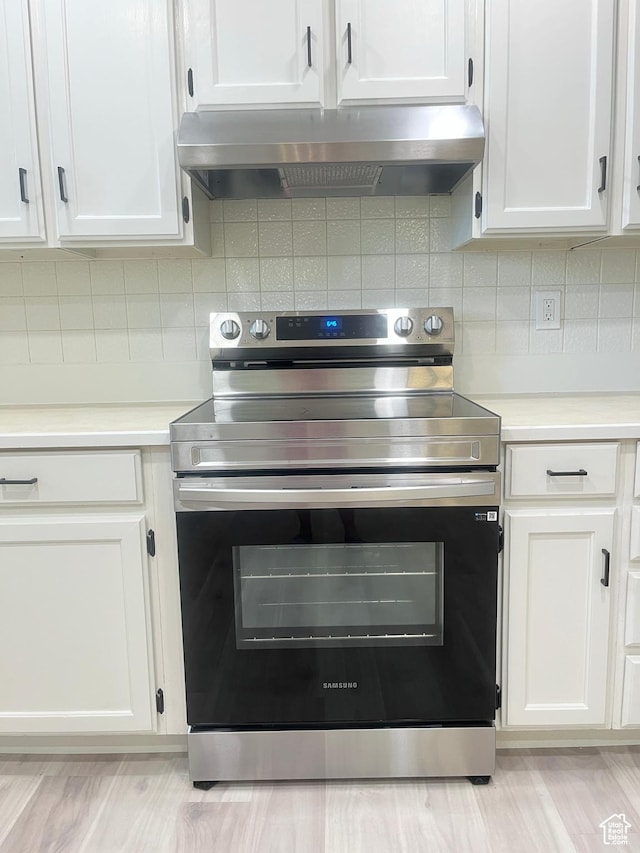 345 E 350 N, Salem, UT 84653 - kitchen with stainless steel electric range oven, wall chimney range hood, white cabinetry, light countertops, and tasteful backsplash