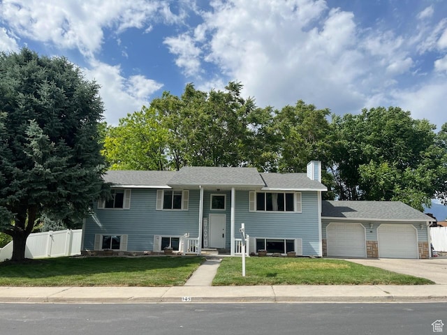 345 E 350 N, Salem, UT 84653 - bi-level home with a garage, driveway, and a chimney