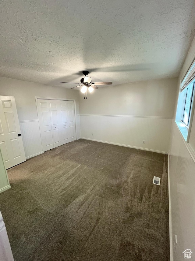345 E 350 N, Salem, UT 84653 - unfurnished bedroom featuring wainscoting, carpet, a textured ceiling, ceiling fan, and a closet