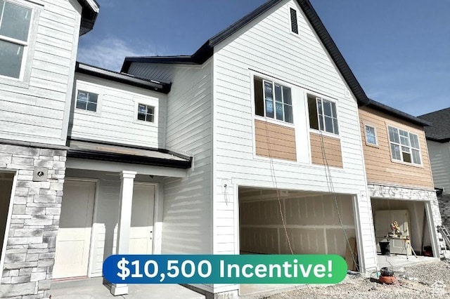 2727 N 2775 W Unit 122, Plain City, UT 84404 - exterior space featuring a garage and stone siding