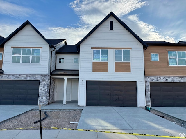 2727 N 2775 W Unit 122, Plain City, UT 84404 - townhome / multi-family property with stone siding, a garage, and driveway