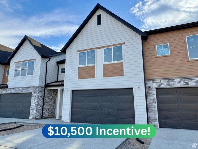 2727 N 2775 W Unit 122, Plain City, UT 84404 - townhome / multi-family property with stone siding and a garage