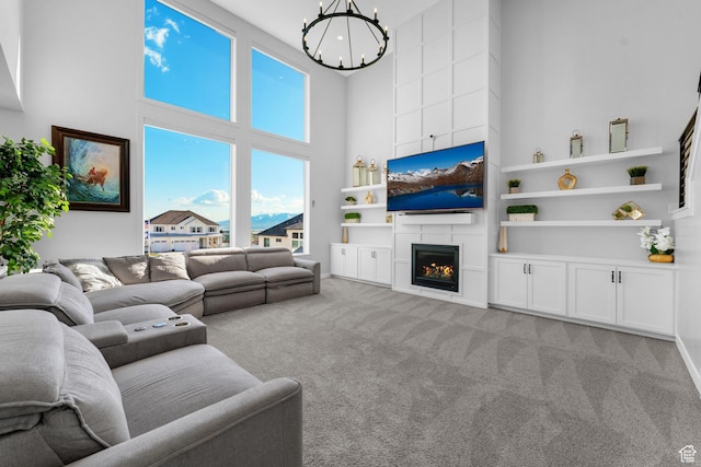827 W 800 N, American Fork, UT 84003 - living room with a towering ceiling, a chandelier, light colored carpet, built in shelves, and a large fireplace