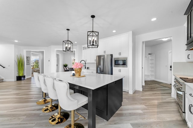 827 W 800 N, American Fork, UT 84003 - kitchen featuring stainless steel appliances, light countertops, recessed lighting, light wood-type flooring, and white cabinets