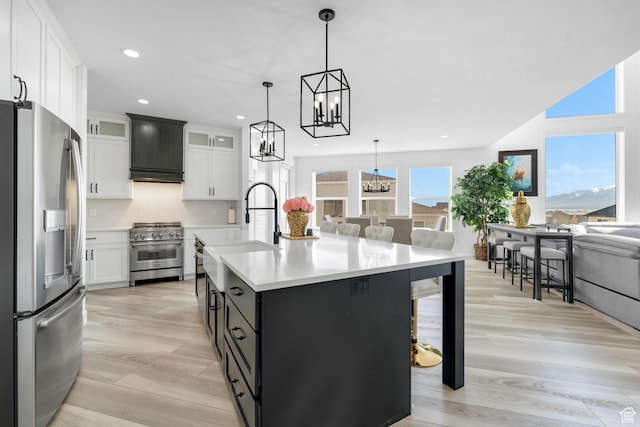 827 W 800 N, American Fork, UT 84003 - kitchen featuring appliances with stainless steel finishes, premium range hood, open floor plan, white cabinets, and light wood-style floors
