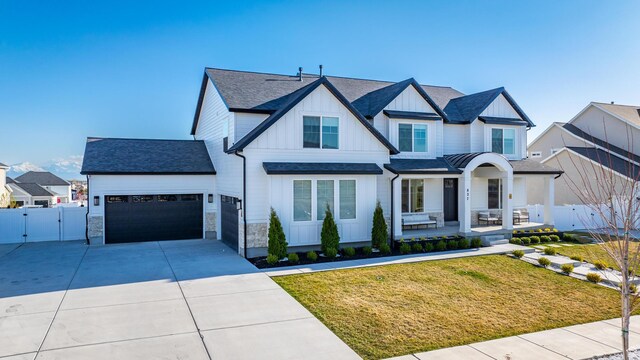 827 W 800 N, American Fork, UT 84003 - modern inspired farmhouse featuring board and batten siding, a gate, an attached garage, concrete driveway, and a porch