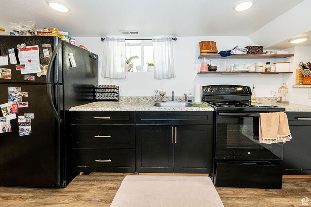 141 W 400 N, Logan, UT 84321 - kitchen featuring black appliances, dark cabinetry, light wood-style flooring, and open shelves