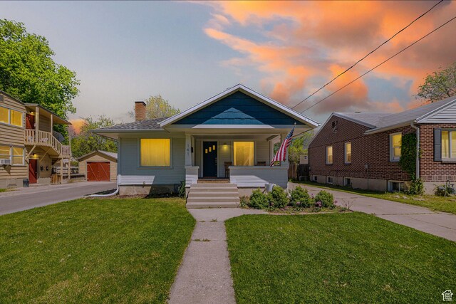 141 W 400 N, Logan, UT 84321 - bungalow-style home featuring a porch, a chimney, a lawn, and an outbuilding