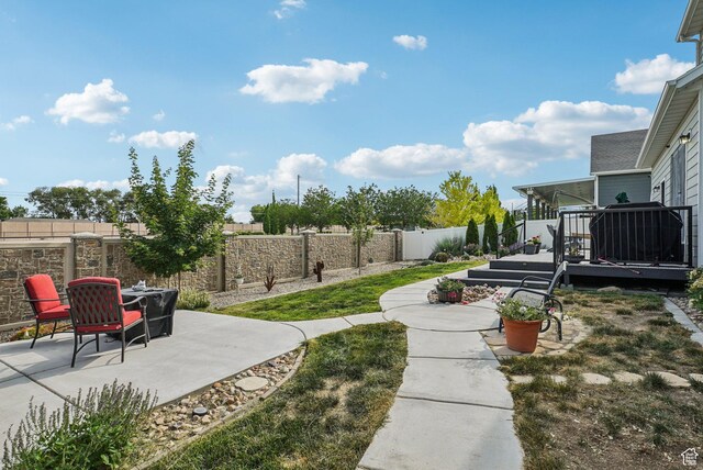 2577 W Garden Creek Way Unit 106, West Jordan, UT 84088 - fenced backyard featuring a patio area and a deck