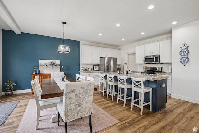 2577 W Garden Creek Way Unit 106, West Jordan, UT 84088 - dining room featuring wood finished floors, recessed lighting, and a chandelier