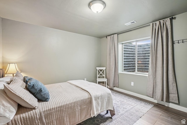 2577 W Garden Creek Way Unit 106, West Jordan, UT 84088 - bedroom with wood finished floors and baseboards