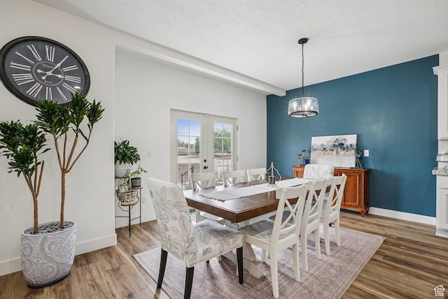 2577 W Garden Creek Way Unit 106, West Jordan, UT 84088 - dining space with light wood-type flooring, french doors, and a chandelier