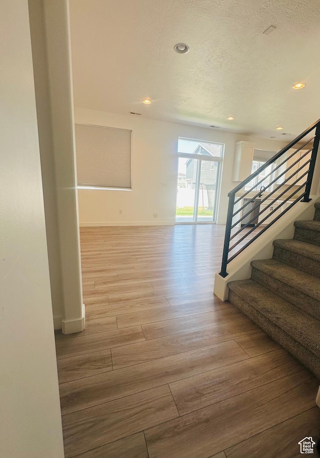 764 S 290 W, American Fork, UT 84003 - corridor featuring wood finished floors, stairs, a textured ceiling, and recessed lighting