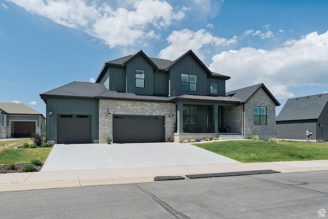 1914 E 540 S, Heber City, UT 84032 - view of front facade featuring board and batten siding, a front yard, an attached garage, driveway, and brick siding