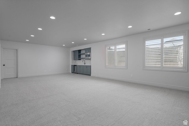 1914 E 540 S, Heber City, UT 84032 - unfurnished living room featuring recessed lighting, light colored carpet, and bar