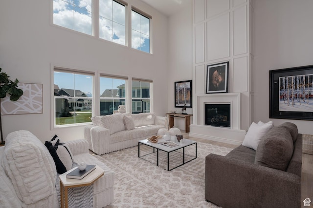 1914 E 540 S, Heber City, UT 84032 - living area featuring a high ceiling, a large fireplace, and wood finished floors