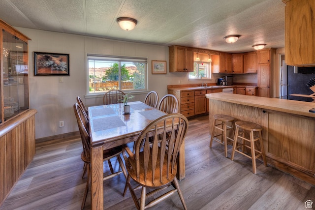 1281 Holyoak Ln E, Moab, UT 84532 - dining area with light wood-style flooring and a textured ceiling