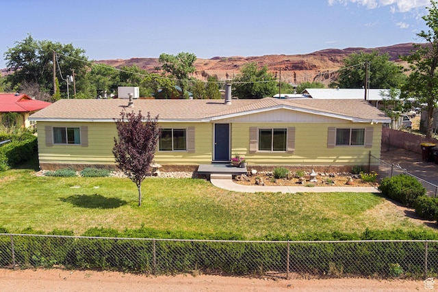 1281 Holyoak Ln E, Moab, UT 84532 - ranch-style house with a mountain view and a fenced backyard