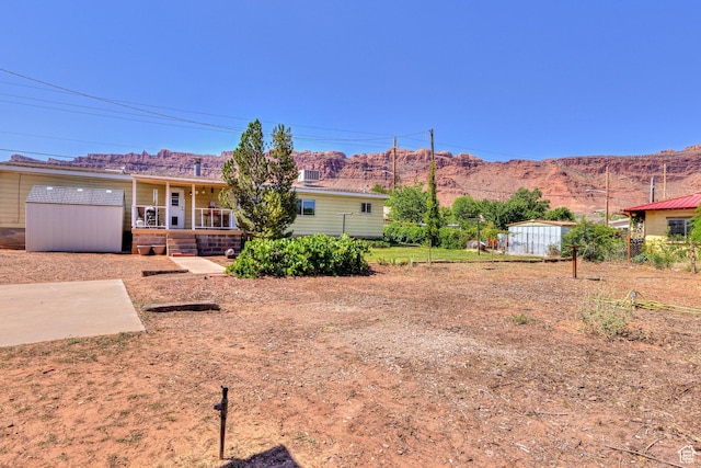 1281 Holyoak Ln E, Moab, UT 84532 - view of front of home featuring a mountain view and a porch