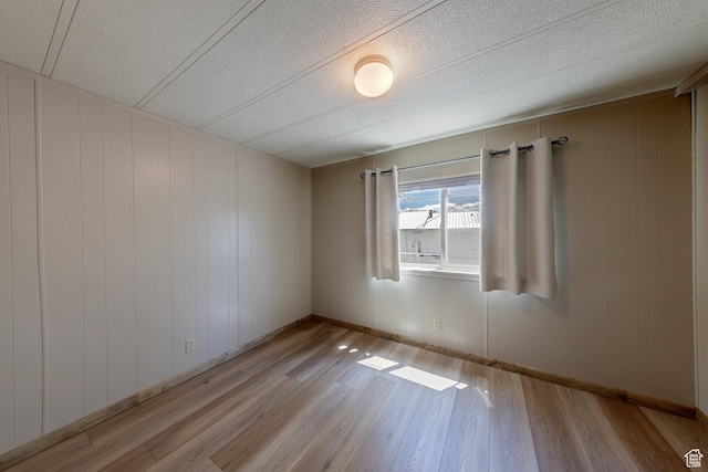 1281 Holyoak Ln E, Moab, UT 84532 - empty room featuring light wood-type flooring and a textured ceiling
