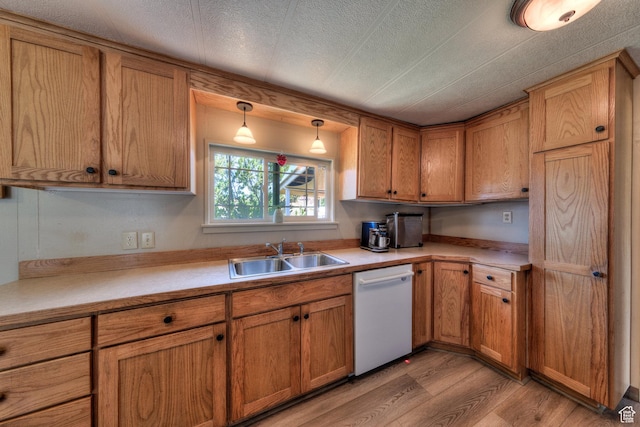 1281 Holyoak Ln E, Moab, UT 84532 - kitchen with white dishwasher, light wood-style floors, light countertops, brown cabinets, and a textured ceiling