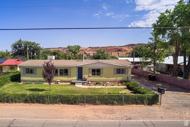 1281 Holyoak Ln E, Moab, UT 84532 - view of front of house with a mountain view and a fenced backyard