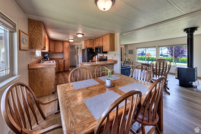 1281 Holyoak Ln E, Moab, UT 84532 - dining area featuring a wood stove and wood finished floors