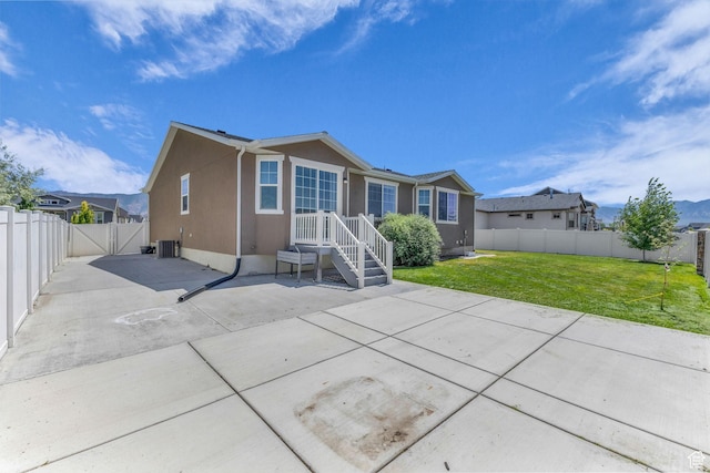 773 W Mulberry St, Stansbury Park, UT 84074 - rear view of house with a patio, a fenced backyard, stucco siding, and a gate