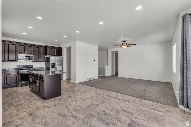 773 W Mulberry St, Stansbury Park, UT 84074 - kitchen with stainless steel appliances, a center island, recessed lighting, light carpet, and dark brown cabinets