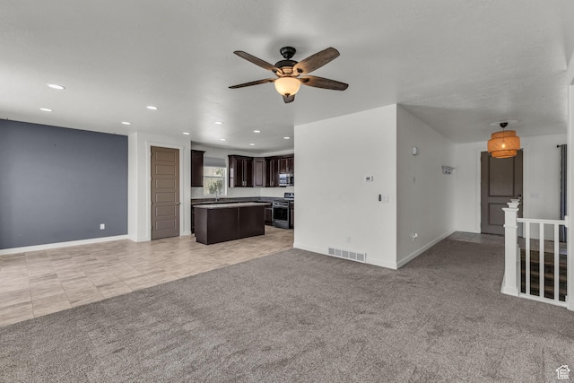773 W Mulberry St, Stansbury Park, UT 84074 - unfurnished living room featuring a ceiling fan, recessed lighting, and light carpet
