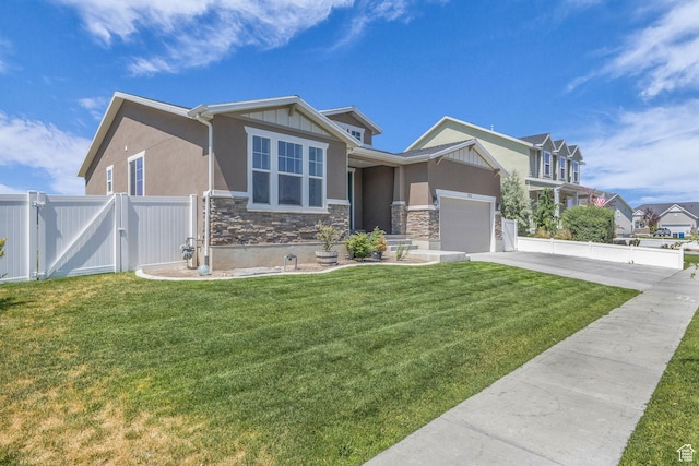 773 W Mulberry St, Stansbury Park, UT 84074 - view of front of property featuring stone siding, a gate, driveway, stucco siding, and a garage
