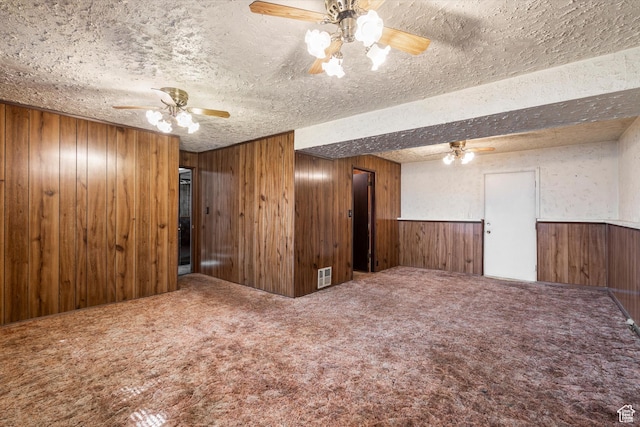 5374 S 5700 W, Hooper, UT 84315 - carpeted spare room with a ceiling fan, wooden walls, a textured ceiling, and wainscoting