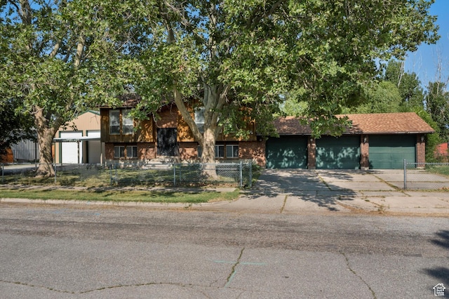 5374 S 5700 W, Hooper, UT 84315 - view of front of property featuring a fenced front yard, brick siding, concrete driveway, and a garage