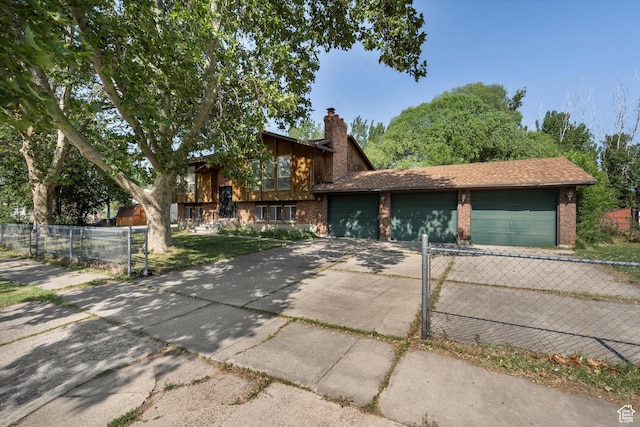5374 S 5700 W, Hooper, UT 84315 - view of front of house with driveway, brick siding, a garage, and a chimney
