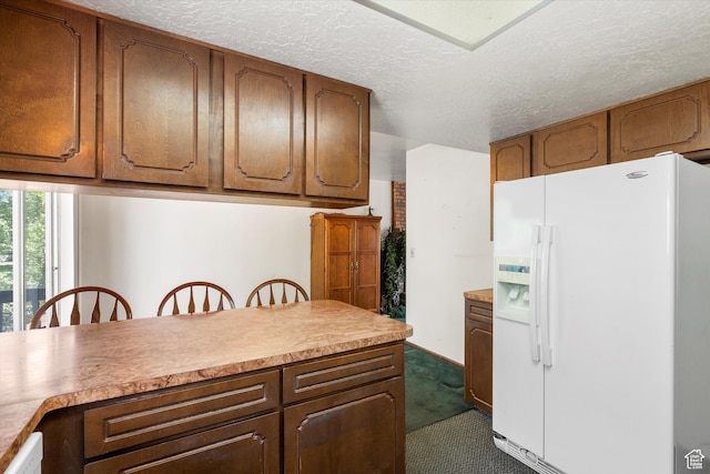 5374 S 5700 W, Hooper, UT 84315 - kitchen with white fridge with ice dispenser, dark colored carpet, light countertops, a textured ceiling, and brown cabinetry