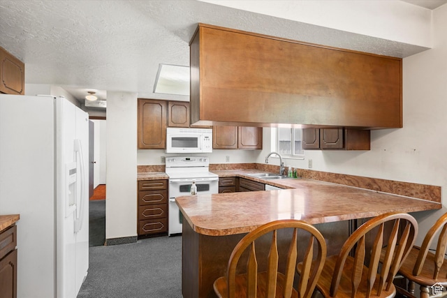 5374 S 5700 W, Hooper, UT 84315 - kitchen featuring white appliances, a peninsula, dark colored carpet, a kitchen breakfast bar, and light countertops